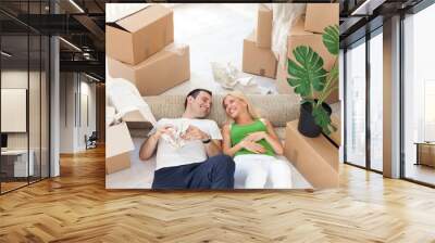 couple relaxing in the middle of boxes Wall mural