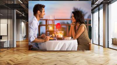 Couple sharing romantic sunset dinner Wall mural