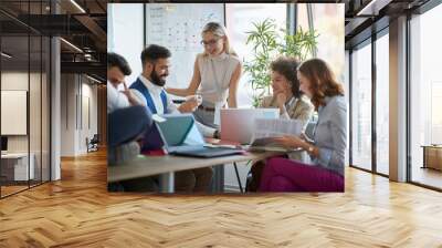 Coworkers  working together as team and discussing ideas Wall mural