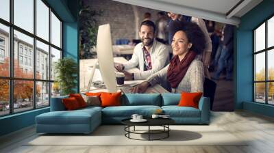 Employed woman at computer in office Wall mural