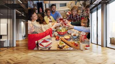 family and friends clinking glasses on Christmas dinner and enjoy in holidays. Wall mural