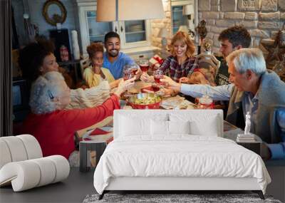 Family having Christmas dinner at home with happy friends Wall mural