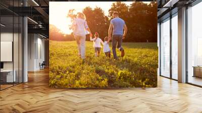 Family in nature together, back view. Wall mural