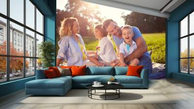 Family with children having fun in nature Wall mural