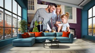 Family with daughter eating in kitchen Wall mural