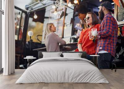 Friends drinking beer in front of food truck; Urban lifestyle concept Wall mural