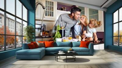 Girl feeding her father in kitchen Wall mural