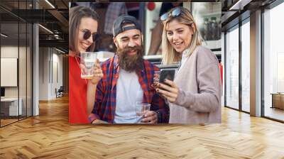 Group of friends hanging out in front of food truck Wall mural