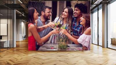 Group of young people with cocktails  having fun in nightclub celebrating. Fun, friendship, celebration concept. Wall mural