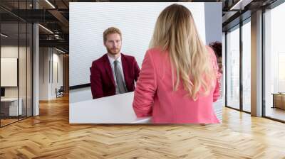 Handsome airport officer talk with female passenger Wall mural