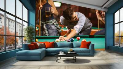 handsome smiling man playing billiard game. Wall mural