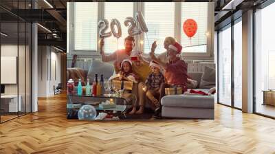 Happy family enjoying New Year eve together. New Year, holiday, family time together Wall mural