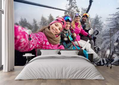 Happy family in cable car climb to ski terrain Wall mural