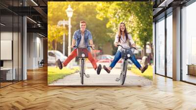 Happy funny couple riding on bicycle Wall mural