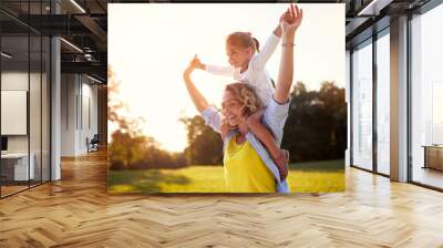 Happy mother with daughter enjoying in park Wall mural