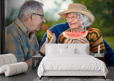 Happy senior couple.mature couple eating watermelon. Wall mural