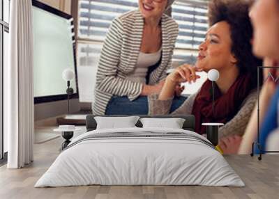 Happy women working together in office Wall mural