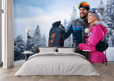 love smiling couple enjoying on winter vacation together on the mountain Wall mural