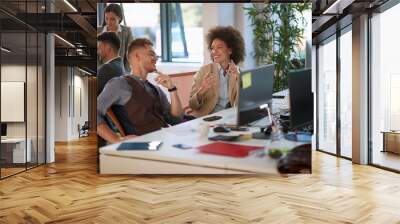 Man and woman sitting at workplace together, multi ethnic business people at table  in office. Wall mural