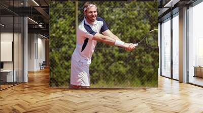 Man with racket on tennis court Wall mural