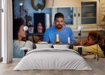 People having Christmas prayer for dinner at home Wall mural