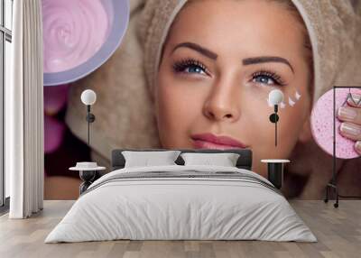 Pretty young woman with facial mask Wall mural