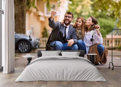 pupil girl and parents after first day of school is over making a photo,. Wall mural