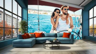 Romantic couple on a yacht enjoy bright sunny day on vacation. Wall mural