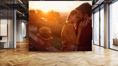 romantic man and woman at sunset. Smiling man and woman is enjoying sunset Wall mural