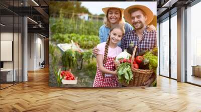 Satisfied farmers family with organic vegetables Wall mural