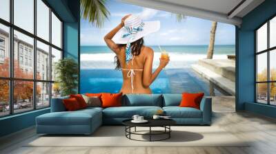 Sexy woman in bikini enjoy in tropical resort Wall mural