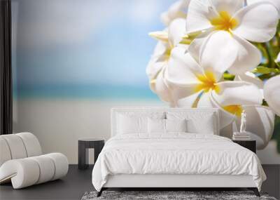 White tropical flower over beautiful beach Wall mural