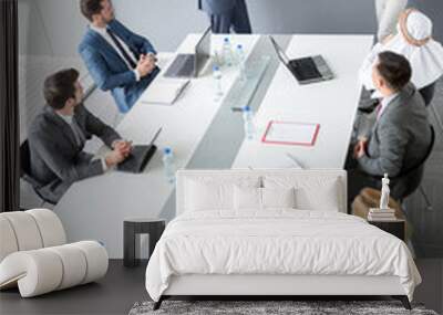 Workers group at meeting table listen manager Wall mural