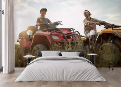 Young couple enjoying a quad  vehicle Wall mural