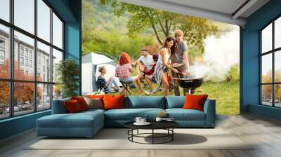 young female and male couple baking barbecue Wall mural