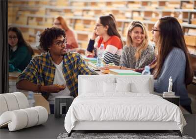 Young freshmen students talking and smiling Wall mural