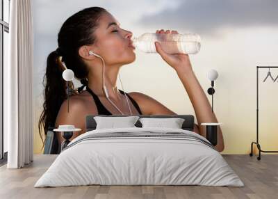 Young sporty woman drinking water Wall mural