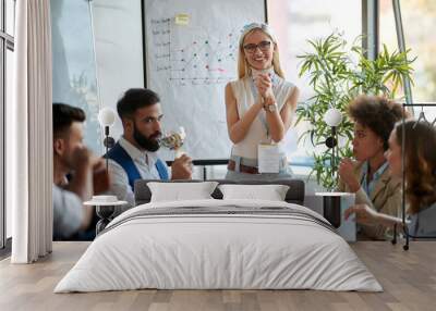 Young woman leading business meeting Wall mural