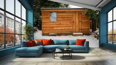 Waney edge wooded garden shed covered in snow after heavy snowfall Wall mural