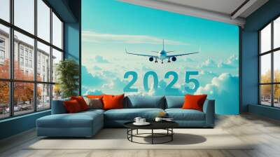 Airplane flying above the clouds on the background of blue sky in the new year 2025. Travel and tourism concept . Wall mural