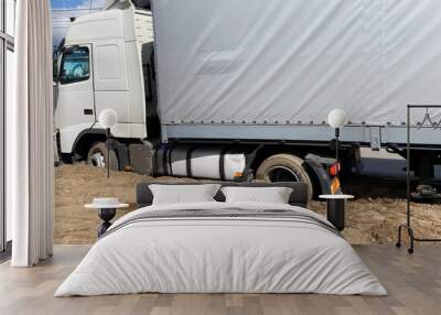 truck stuck in the sand on the side of the road. Wall mural