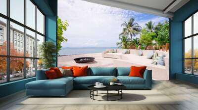 A seating place on a beach with pillows at the hotel Wall mural