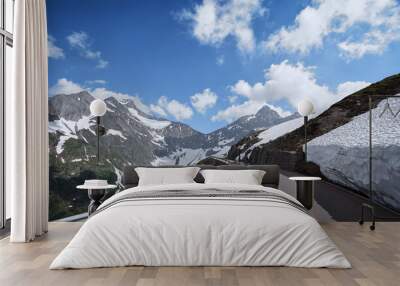 Asphalt road in Alp mountains. Road trip concept. Beautiful landscape. Wall mural