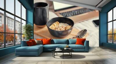 Breakfast in bed: a wooden tray with granola and cup of cocoa with a laptop on background. Wall mural