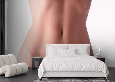 Close up of slim young woman belly isolated on white. Wall mural