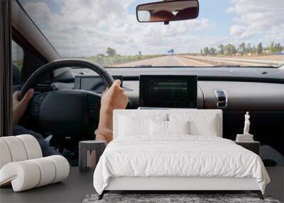 Driver driving a car on asphalt road. Wall mural