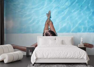 Enjoying suntan and vacation. Beautiful young woman in swimming pool. Wall mural