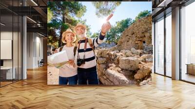 Family, age, tourism and travel concept. Happy senior couple with map at ancient sightseeing. Wall mural