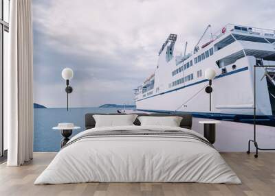 ferryboat loading or unloading by a port pier. concept of transportation and traveling. Wall mural