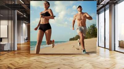 Healthy lifestyle. Jogging outdoors. Young man and woman is running on the sand beach. Wall mural